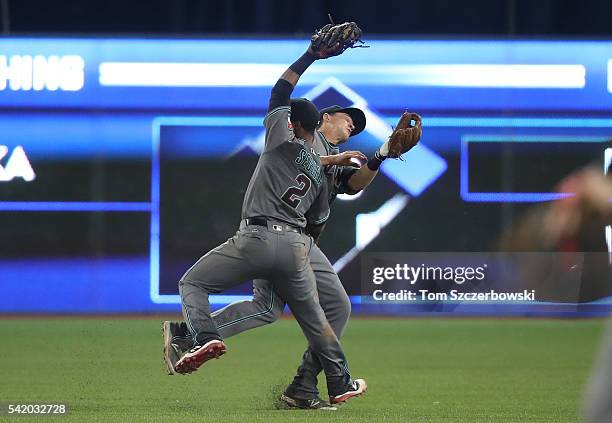 Jean Segura of the Arizona Diamondbacks catches a soft pop fly as he nearly collides with Nick Ahmed in the ninth inning during MLB-game action...