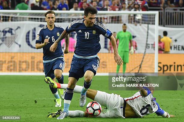 Argentina's Lionel Messi takes the ball past USA's John Brooks during their Copa America Centenario semifinal football match in Houston, Texas,...
