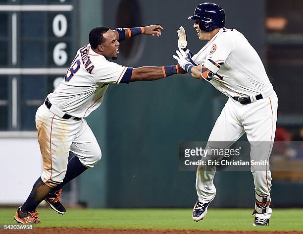Carlos Correa of the Houston Astros celebrates his two-run, walk-off single with Luis Valbuena during the ninth inning against the Los Angeles Angels...