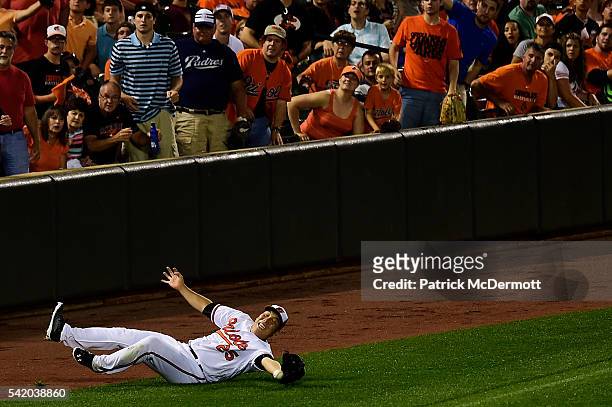 Hyun Soo Kim of the Baltimore Orioles is unable to catch a foul ball off the bt of Ryan Schimpf of the San Diego Padres in the fifth inning during a...