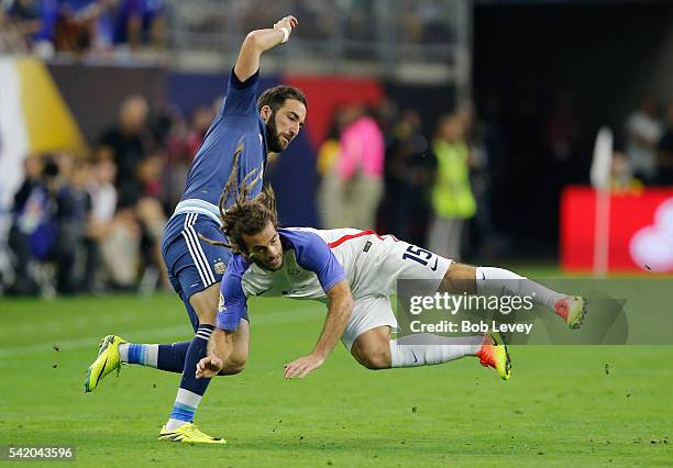 Kyle Beckerman of United States falls in the first half as Gonzalo Higuain of Argentina reacts during a 2016 Copa America Centenario Semifinal match...