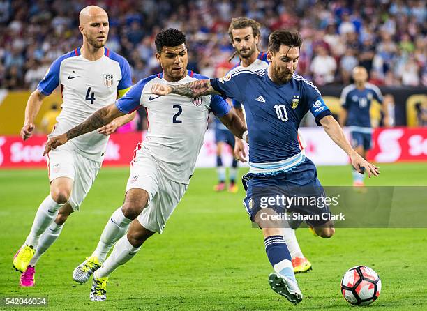 Lionel Messi of Argentina takes a shot as DeAndre Yedlin of United States defends during the Copa America Centenario Semifinal match between United...