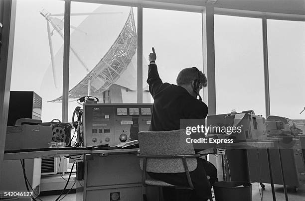 Staff in the equipment rooms overlooking the Doppler weather radar with 25 metre antenna at Chilbolton Observatory, Hampshire, England,13th April...