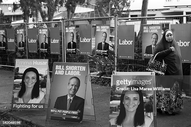 Image has been shot in black and white, no colour version available.) A woman walks past Labor signage as she arrives at the Australian Labor Party...