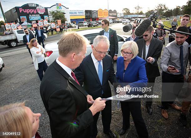 Prime Minister Malcolm Turnbull speaks with Liberal Member for Forde Bert Van Manen and Liberal Member for McPherson Karen Andrews beside the M1...