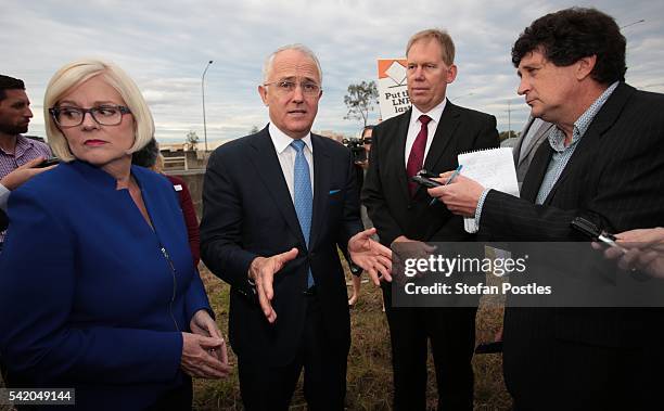 Prime Minister Malcolm Turnbull speaks with Liberal Member for Forde Bert Van Manen and Liberal Member for McPherson Karen Andrews beside the M1...