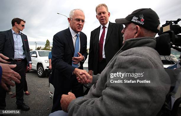 Prime Minister Malcolm Turnbull shakes hands a local pensioner beside the M1 Highway, Yatala on June 22, 2016 on the Gold Coast, Australia. Malcolm...