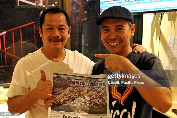 Photographer Arturo De Vera while taking souvenir photo with Manila Bulletin Chief Photographer Albert Garcia with his Manila Bulletin Newspaper...