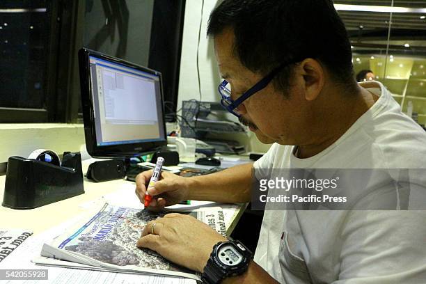 Manila Bulletin Chief Photographer Albert Garcia doing autographs with several newspaper copy of Mt. Pinatubo Eruption at his Manila Bulletin office,...