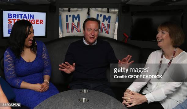 British Prime Minister David Cameron gestures as he talks with Founder of Isabella Queen bags, Isabelle Ugochukwu , and Labour's Harriet Harman, as...