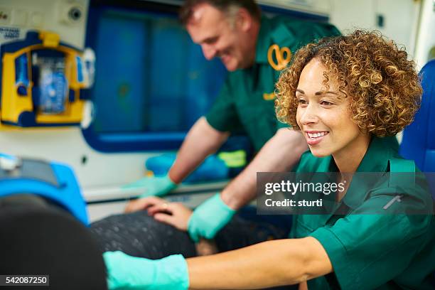 paramedics with patient in good spirits - paramedic stock pictures, royalty-free photos & images