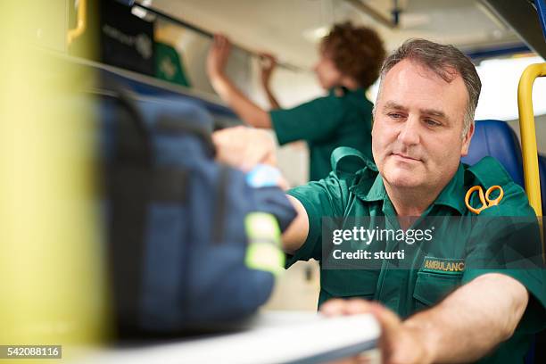 busy paramedic in the ambulance - rescue services occupation stock pictures, royalty-free photos & images