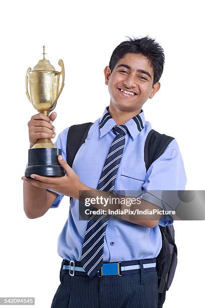 portrait of teenage boy holding winning trophy against white background - life after stroke awards 2011 ストックフォトと画像