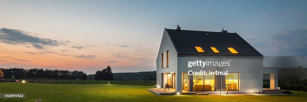 Modern house with garden at night