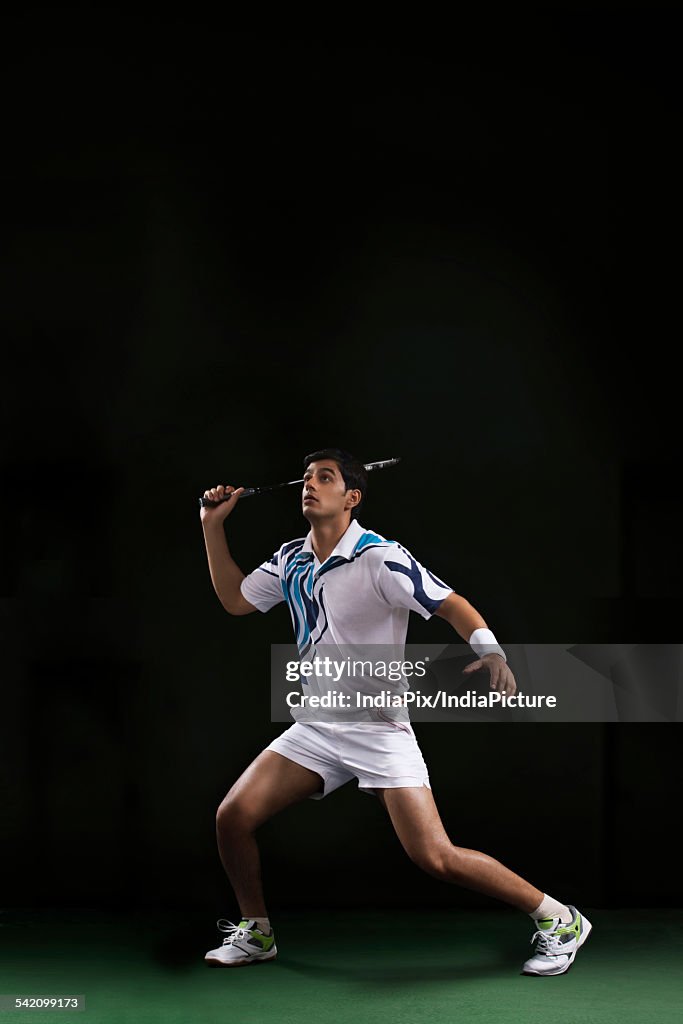 Full length of man playing badminton at court