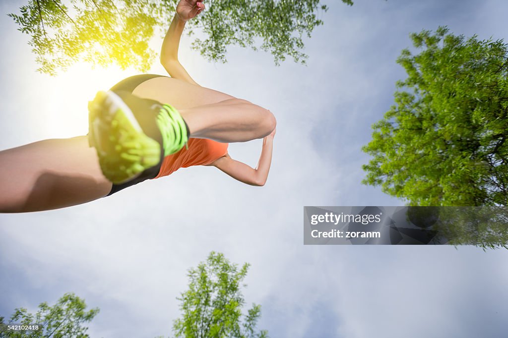 Woman running, mid-air