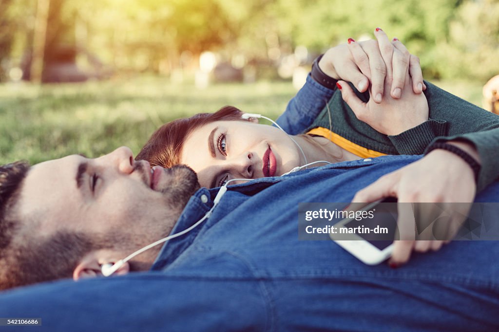 Relaxed couple enjoying the music in the park