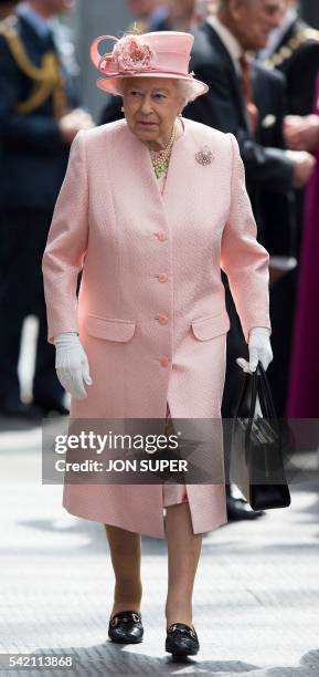 Britain's Queen Elizabeth II walks along the platform after arriving by Royal Train at Liverpool Lime Street Station in Liverpool, north-west England...