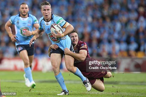 James Maloney of the Blues is tackled by Jacob Lillyman of the Maroons during game two of the State Of Origin series between the Queensland Maroons...