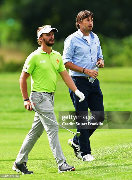 Former European Tour player Robert Jan Derksen walks with Joost Luiten of The Netherlands during the Pro - Am event prior to the start of the BMW...