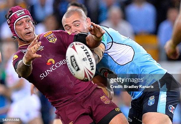 Johnathan Thurston of the Maroons offloads during game two of the State Of Origin series between the Queensland Maroons and the New South Wales Blues...