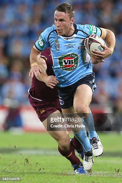 James Maloney of the Blues is tackled by Jacob Lillyman of the Maroons during game two of the State Of Origin series between the Queensland Maroons...