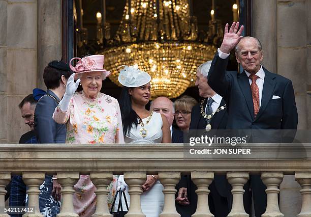 Britain's Queen Elizabeth II and her husband Britain's Prince Philip, Duke of Edinburgh waves to members of the public from the balcony of Liverpool...