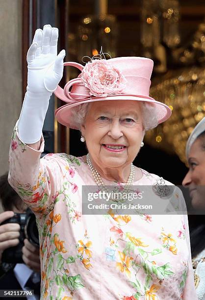 Queen Elizabeth II waves from the balcony of the Town Hall during a visit to Liverpool on June 22, 2016 in Liverpool, England.