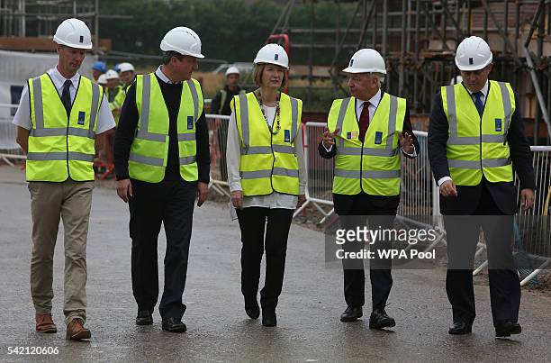 British Prime Minister David Cameron , and Labour MP Harriet Harman listen to Crest Nicholson CEO Stephen Stone, as they tour a Crest Nicholson...