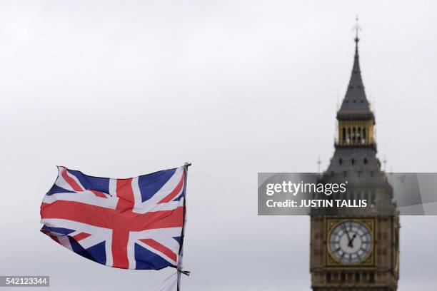 Union flag flies in the wind in front of the Big Ben clock face and the Elizabeth Tower at the Houses of Parliament in central London on June 22...