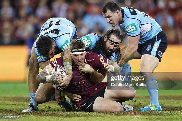 Jacob Lillyman of the MaroJosh McGuire of the Maroons is tackled during game two of the State Of Origin series between the Queensland Maroons and the...