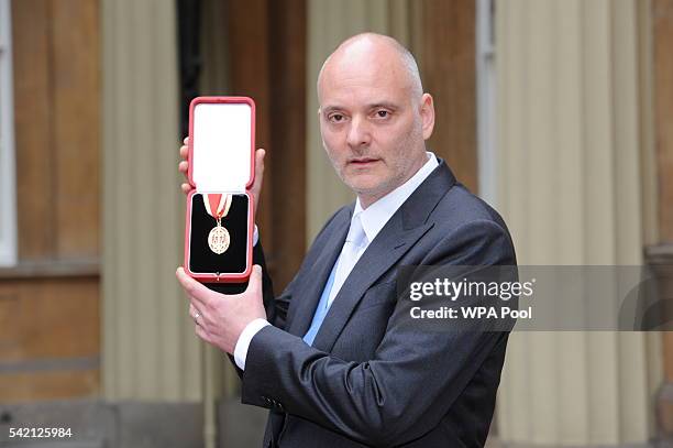 Sir Michael Jacobs poses after he was made a Knight Bachelor by the Princess Royal during an investiture ceremony at Buckingham Palace on June 22,...