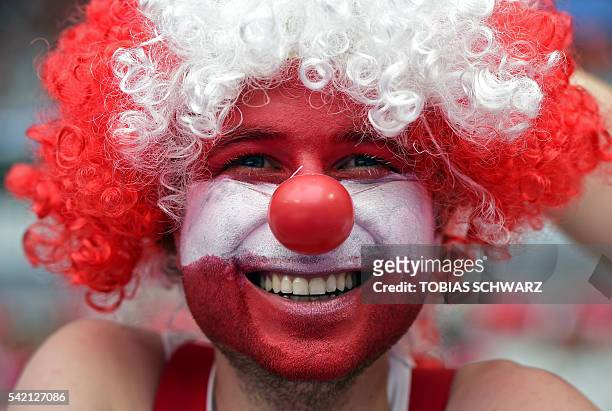 An Austria fan in red and white waits for the start of the Euro 2016 group F football match between Iceland and Austria at the Stade de France...