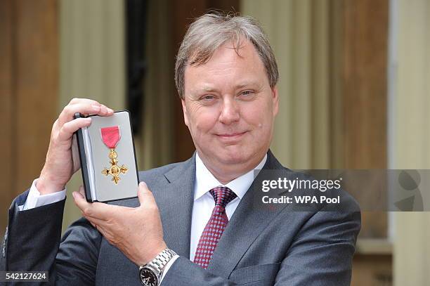 British Cycling President Robert Howden poses after he received his Officer of Order of the British Empire medal from the Princess Royal during an...