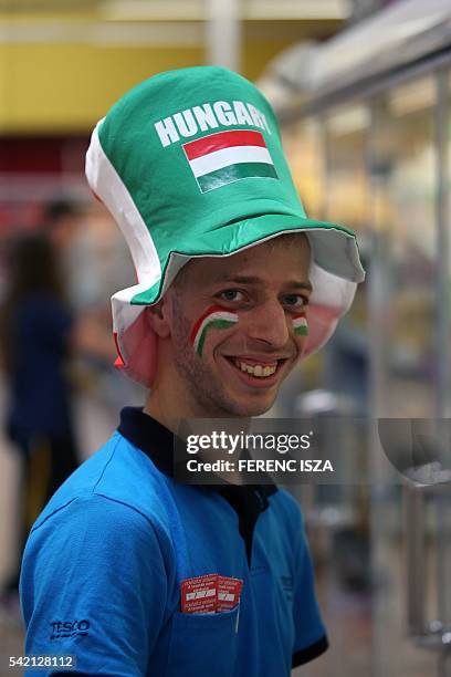 Hungarian Tesco employee wears grey tracksuit bottoms like their national goalkeeper Gabor Kiraly and tricolors supporting the Hungarian national...