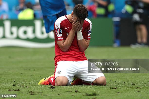 Austria's defender Aleksandar Dragovic reacts after missing a penalty shot during the Euro 2016 group F football match between Iceland and Austria at...