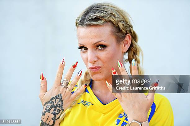 Sweden fan, with nails painted in the falgs of different nations, enjoys the build up to the UEFA EURO 2016 Group E match between Sweden and Belgium...