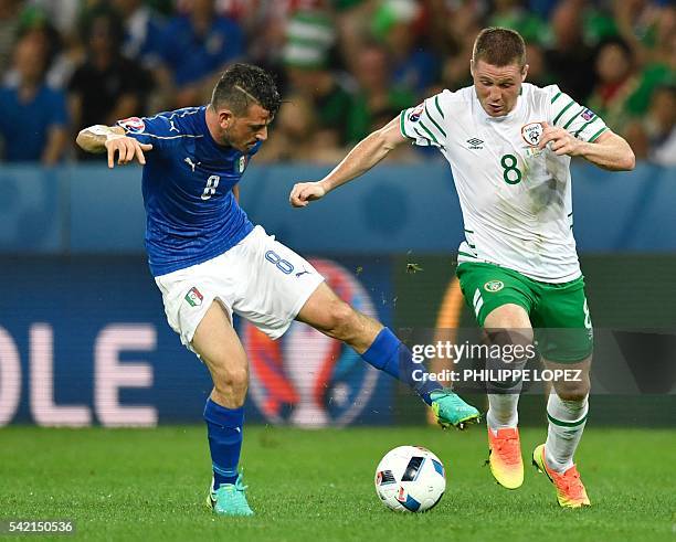 Ireland's midfielder James McCarthy and Italy's midfielder Alessandro Florenzi vie for the ball during the Euro 2016 group E football match between...