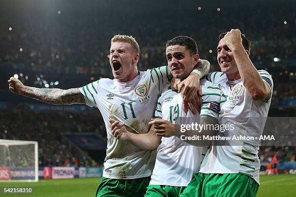 Robbie Brady of Ireland celebrates with team-mates James McClean and Stephen Ward at the end of the UEFA EURO 2016 Group E match between Italy and...