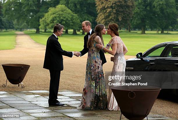 Prince William and Catherine, Duchess of Cambridge are greeted by David Cholmondeley, Marquess of Cholmondeley and Rose Cholmondeley, the Marchioness...