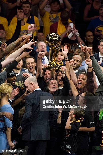 Finals: Cleveland Cavaliers owner Dan Gilbert victorious, holding up Larry O'Brien trophy with team after winning series vs Golden State Warriors at...