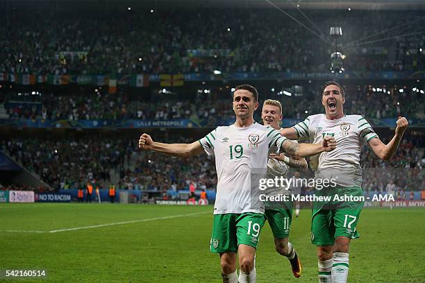 Robbie Brady of Ireland celebrates with team-mates James McClean and Stephen Ward at the end of the UEFA EURO 2016 Group E match between Italy and...