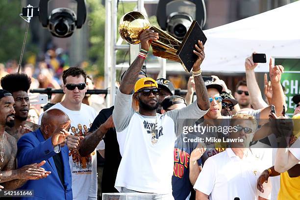 LeBron James of the Cleveland Cavaliers holds up the Larry O'Brien Trophy during the Cleveland Cavaliers 2016 NBA Championship victory parade and...