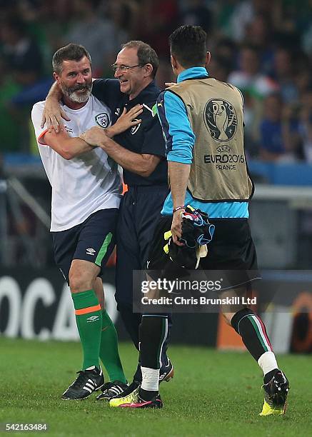 Republic of Ireland manager Martin O'Neill celebrates at full-time with assistant coach Roy Keane as Gianluigi Buffon of Italy approaches to...