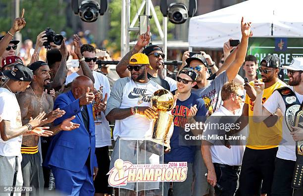 LeBron James of the Cleveland Cavaliers holds up the Larry O'Brien Trophy during the Cleveland Cavaliers 2016 NBA Championship victory parade and...