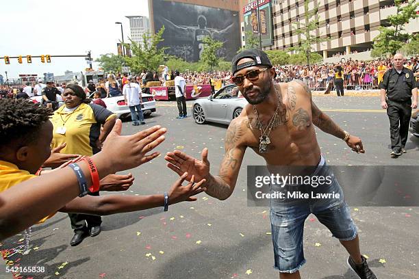 Mo Williams of the Cleveland Cavaliers greets fans along the parade route during the Cleveland Cavaliers 2016 NBA Championship victory parade and...