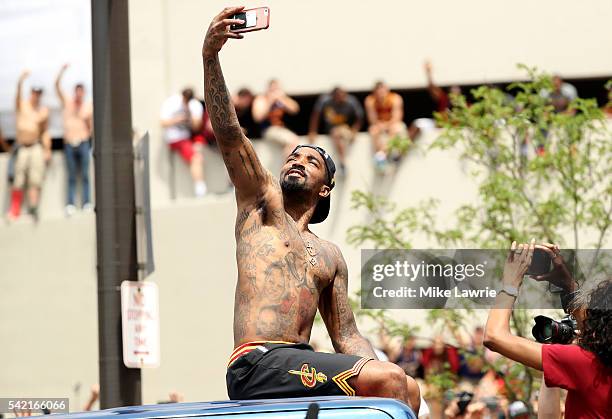 Smith of the Cleveland Cavaliers takes a photo as the crowd cheers during the Cleveland Cavaliers 2016 NBA Championship victory parade and rally on...