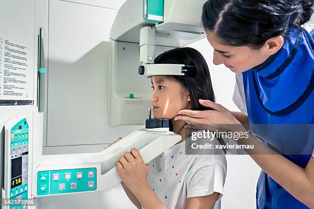 nurse preparing child for a teeth x-ray - child dental emergencies stock pictures, royalty-free photos & images