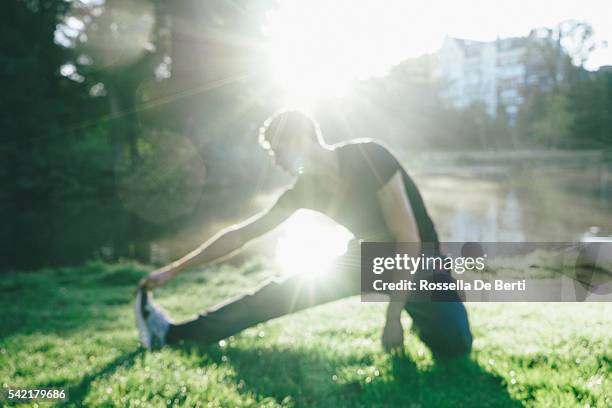 young beautiful man exercising outdoors in the early morning - running netherlands stock pictures, royalty-free photos & images