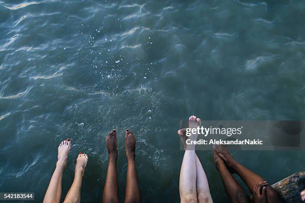 enjoying on the dock - female feet stockfoto's en -beelden